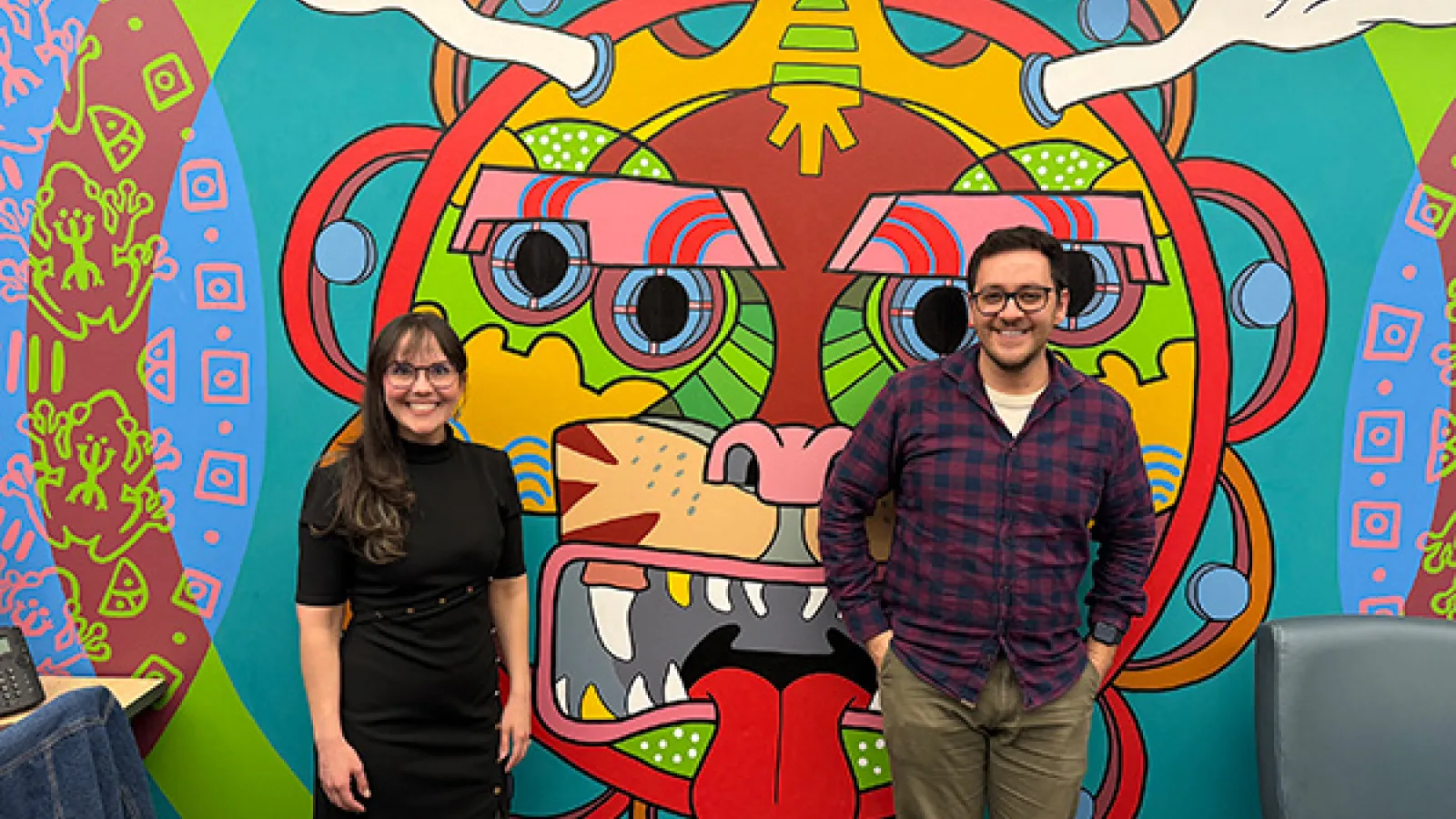 javier and guest speaker in front of sppo mural