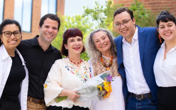 Group of six individuals smiling