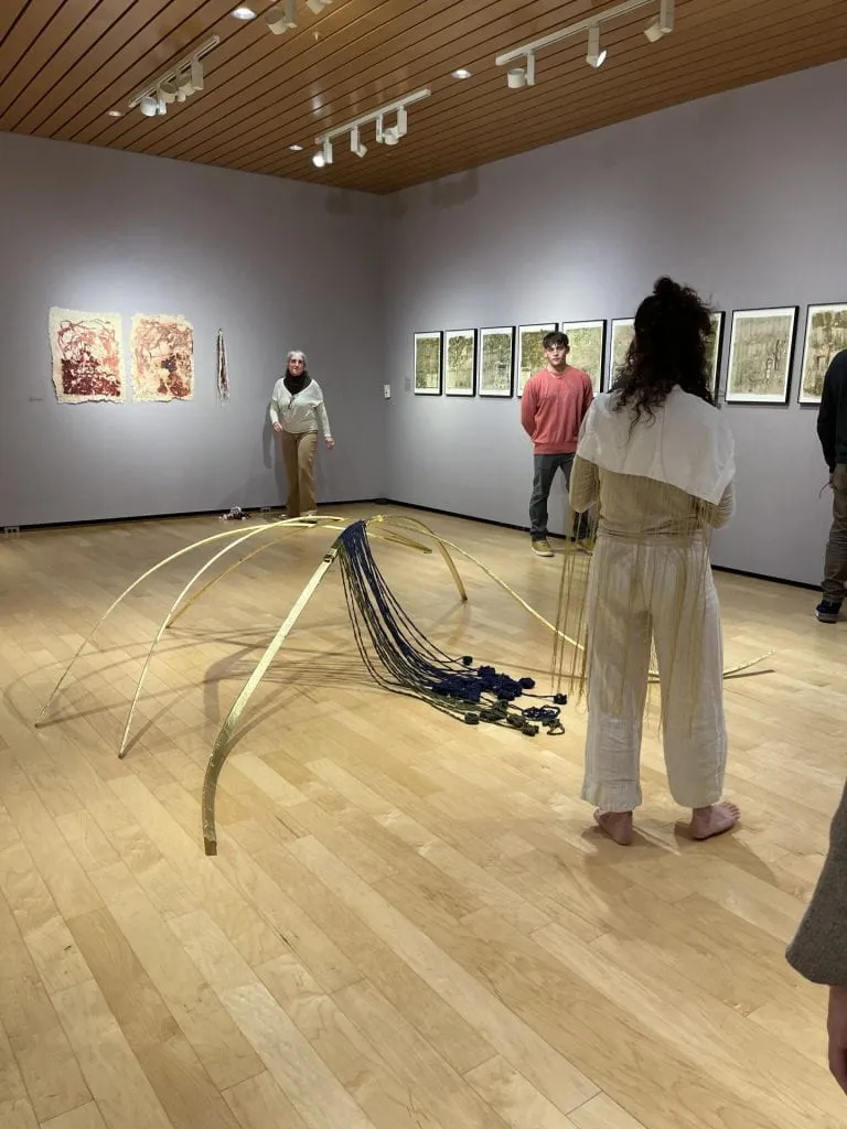 Art gallery with viewers walking by
