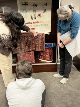 Kawsay Shadowbox with people surrounding it